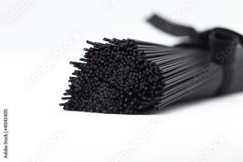 Black pasta on a white background. Black spaghetti