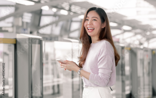 Woman chatting on mobile phone while standing on railway station Free Download Woman chatting on mobile phone while standing on railway station - GFXLoad