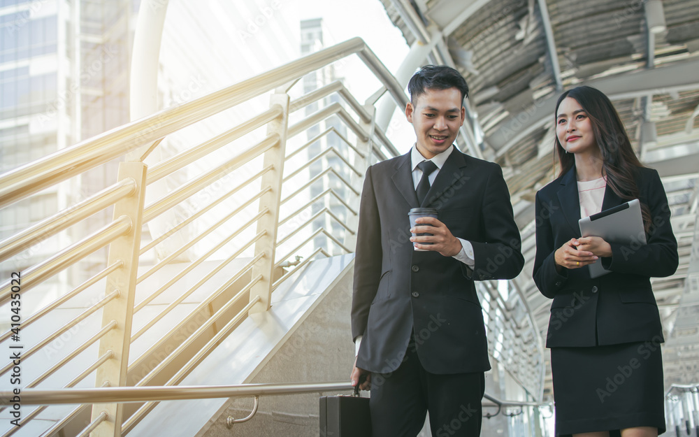 Two business man and woman talking and walking outside Two business man and woman talking and walking outside