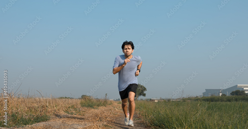Athletic young asian man running jogging in the nature at morning, Young men exercise in the morning Athletic young asian man running jogging in the nature at morning, Young men exercise in the morning