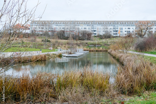 The snow-covered harbour in Leipzig's Neulindenau district in winter with icy paths and river. photo