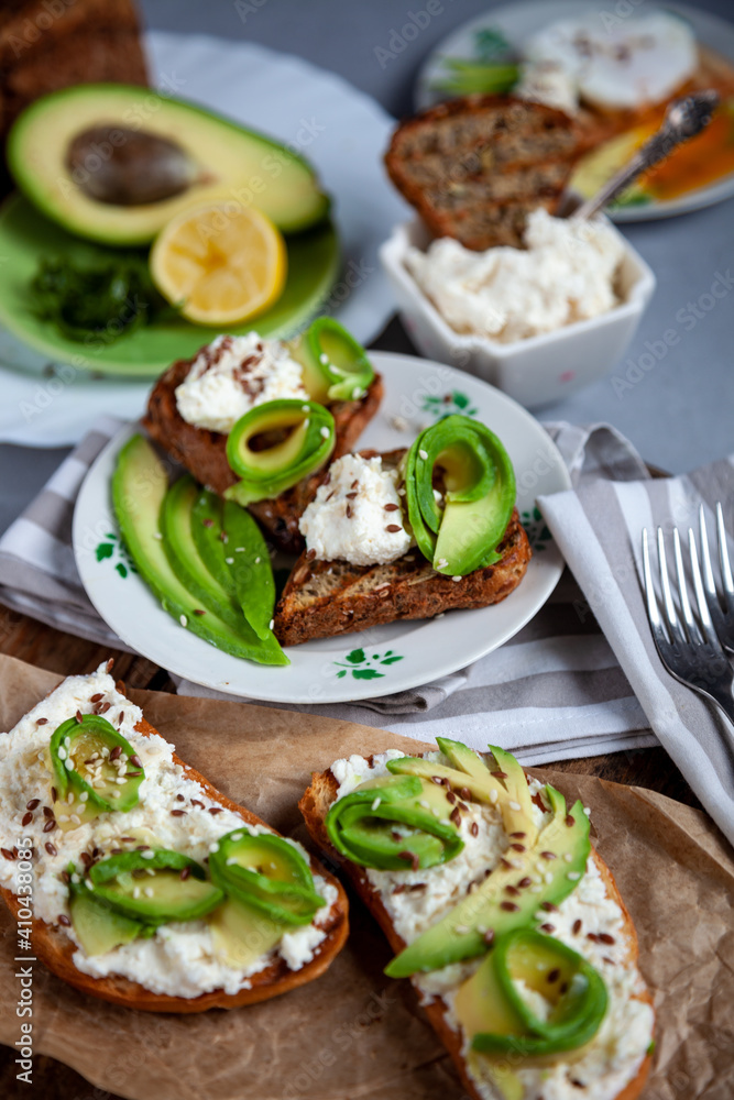 Sandwiches with soft cheese, avocado and cucumber. Breakfast is on the table. Healthy food. Toast and spread on it. Avocado sandwich stilllife. Healthy food. Toast.
