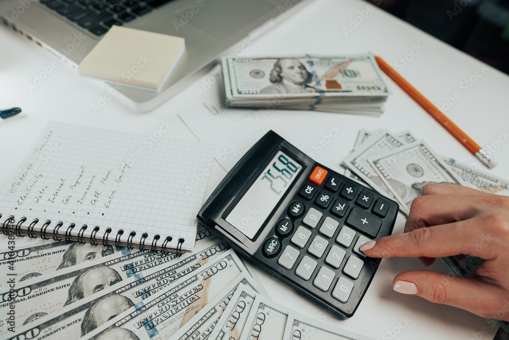 Close-up of old analog calculator. Young woman counts numbers on device, keeps track of money. Student does homework, teaching mathematics. Close-up of old analog calculator. Young woman counts numbers on device, keeps track of money. Student does homework, teaching mathematics.