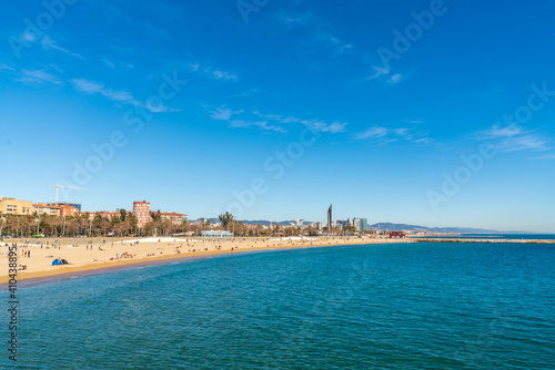 BARCELONA, SPAIN, FEBRUARY 3, 2021: Barcelona beach a sunny winter day. During the covid-19 pandemic. View from inside the water.