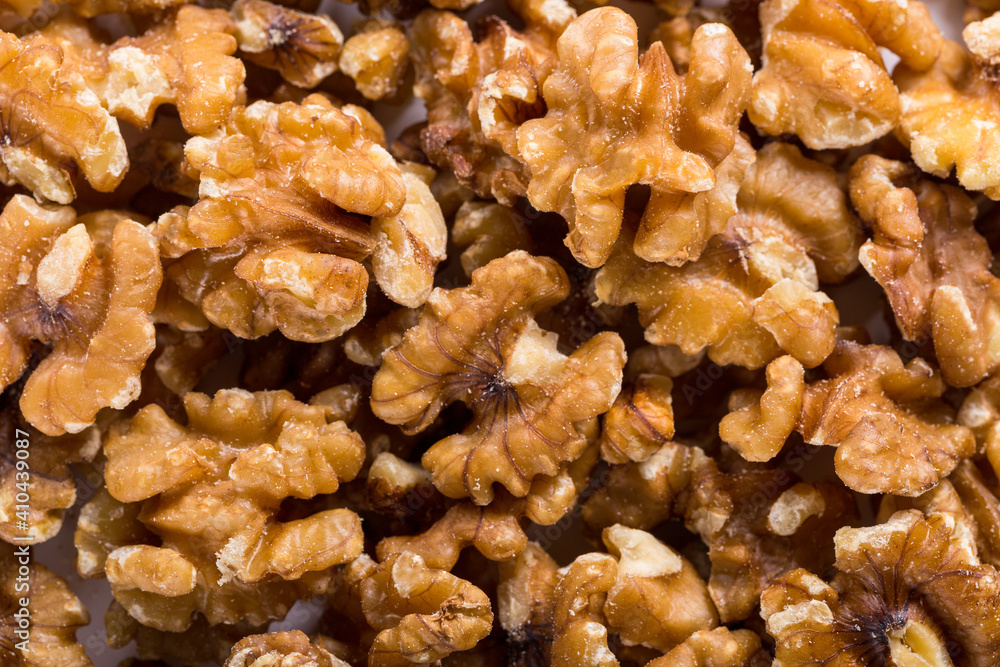 Background of big raw peeled walnuts situated arbitrarily. Background of big raw peeled walnuts situated arbitrarily.