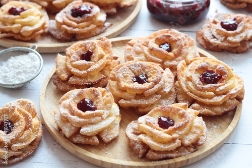 Carnival roses with jam and powdered sugar - traditional Polish cookies eaten during carnival and fat Thursday