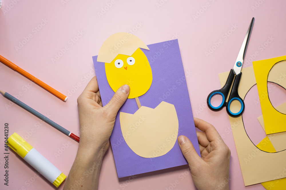 Fototapeta premium Easter greeting card in egg shape. How to make children's paper craft. Step 9. Simple creative art project. Step by step instructions. Homemade easy paper applications. DIY concept.