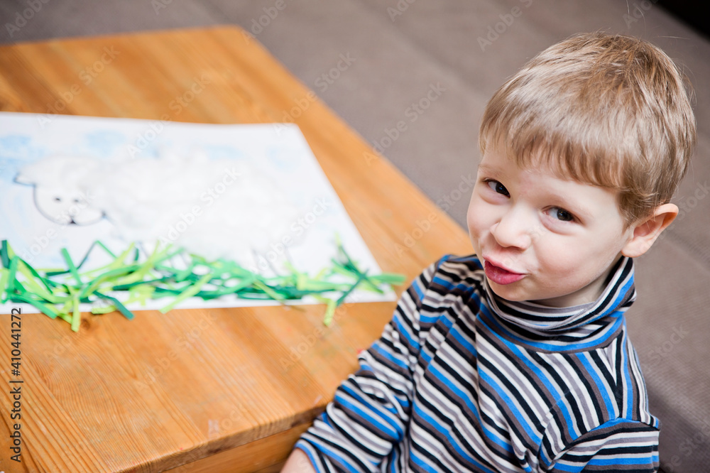 preschool education, independent work, DIY task. kid making a sheep from natural cotton-wool. early learning, concentrated look. preschool education, independent work, DIY task. kid making a sheep from natural cotton-wool. early learning, concentrated look.