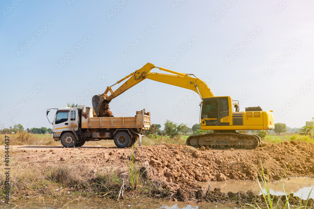 Backhoe loader soil from the ground up to dump truck. Backhoe loader soil from the ground up to dump truck.