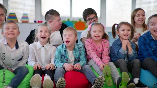 Wallpaper Mural children with disabilities spending time with healthy kids, boys and girls smiling at the camera sitting on beanbag chairs Torontodigital.ca