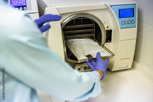 dental hygienist sterilizing clinical material