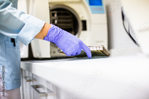 dental hygienist sterilizing clinical material