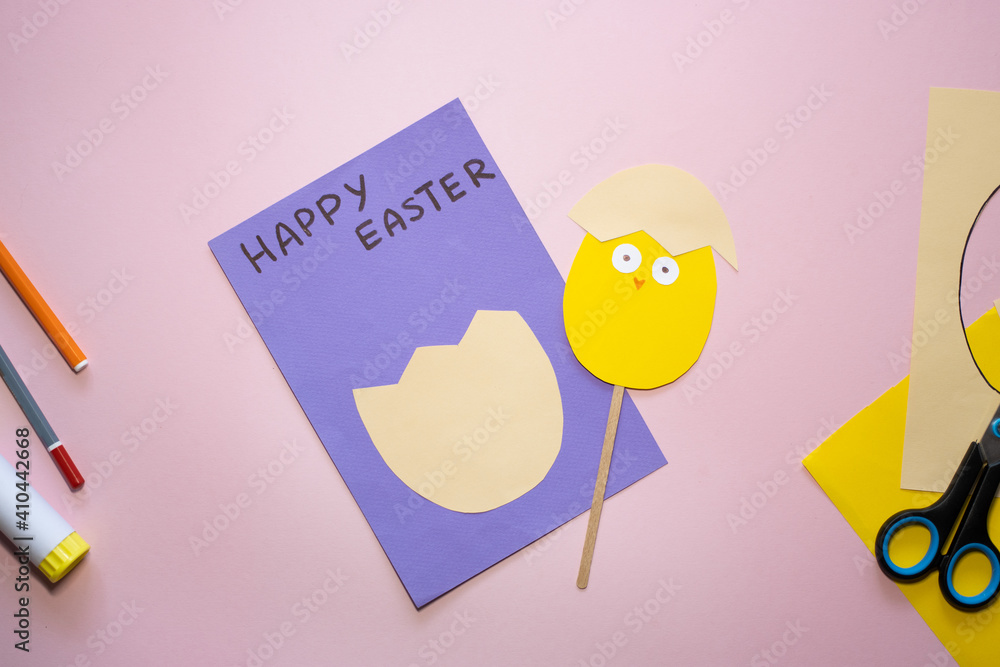 Fototapeta premium Easter greeting card in egg shape. How to make children's paper craft. Step 12. Simple creative art project. Step by step instructions. Homemade easy paper applications. DIY concept.