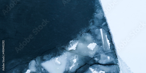 Glacier and iceberg landscape. Ice floes on the water. Ice drift, natural panoramic winter background. Ice surface of the frozen water