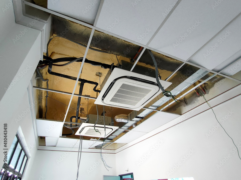 SELANGOR, MALAYSIA -MARCH 2, 2021: Installation of ceiling cassette air-condition. Mounted on the ceiling, and has the ability to cool the space more efficiently.