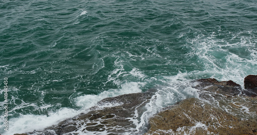 Ocean waves splash against rocks