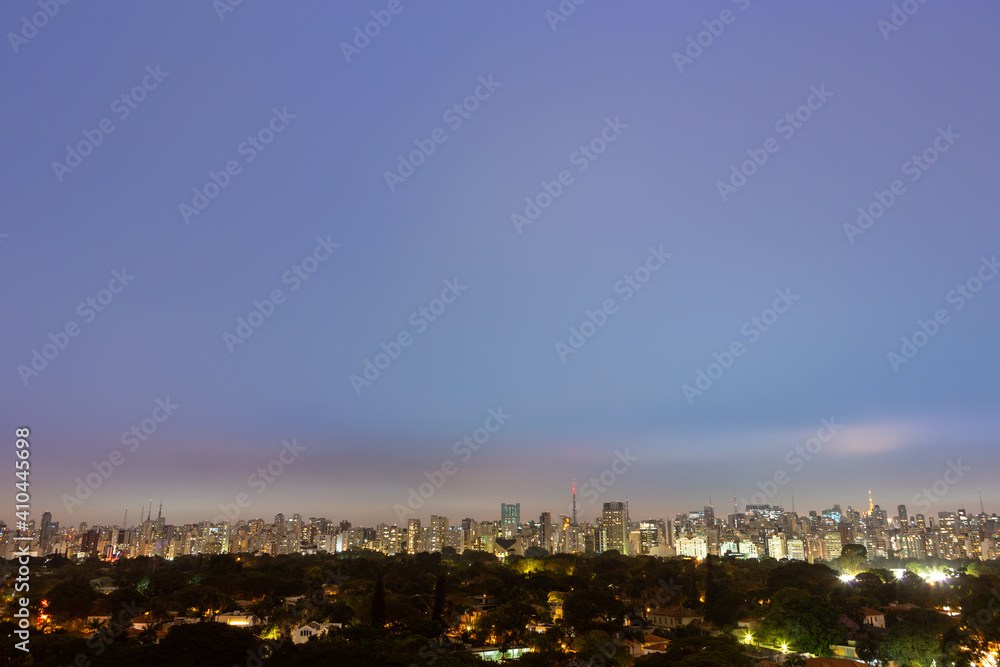 Aerial view of São Paulo city skyline at night, park, streets, houses, trees and buildings in the background at dusk. Concept of urban, city, architecture, cityscape, metropolis, business, tourism.