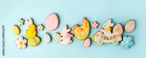 Set of Colorful easter cookies on blue background, assortment sweet gifts, seasonal springtime holiday greeting card, creative idea for decor, event menu, funny cute food, banner, flyer, invitation