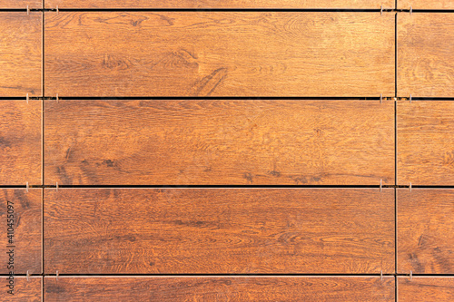 Building cladding with a ventilated facade, wooden texture, brown wood pattern photo