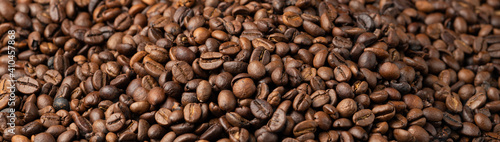 Roasted coffee beans background. Selective focus, macro, banner