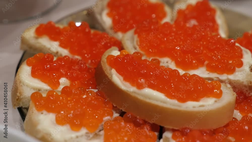 Sandwiches with butter and red caviar close-up Sandwiches with butter and red caviar close-up