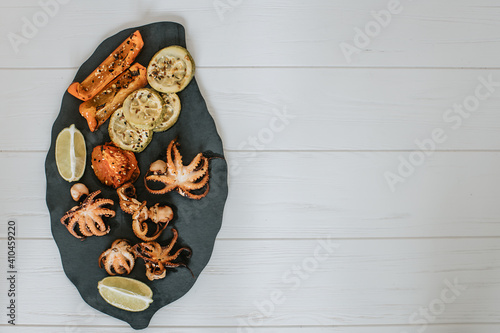 grilled octopuses on top with a place under the text 