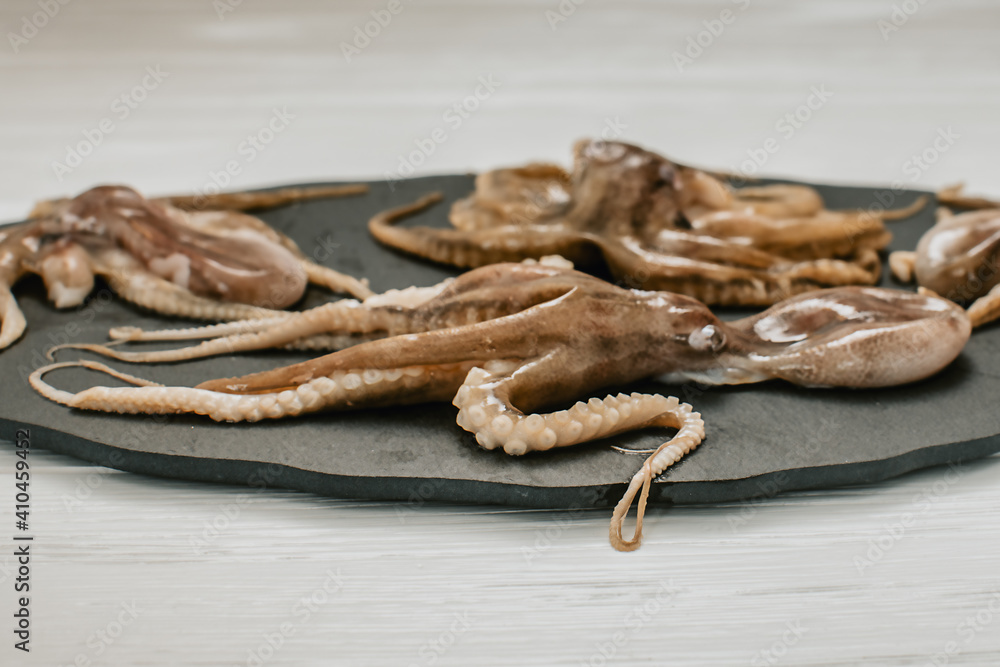 Obraz premium fresh octopuses on a light background 