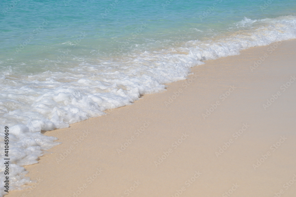 Waves gently lapping on to golden sand on a beautiful tropical beach. Waves gently lapping on to golden sand on a beautiful tropical beach.