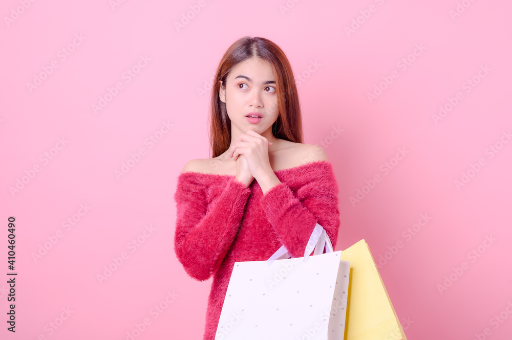 A beautiful Asian woman is happy  when there is a shopping motive to buy the products she wants such as a discount promotion
