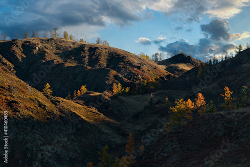 Russia. Mountain Altai. Expressive graphics of autumn sunlight on the rocks of mountain ranges.