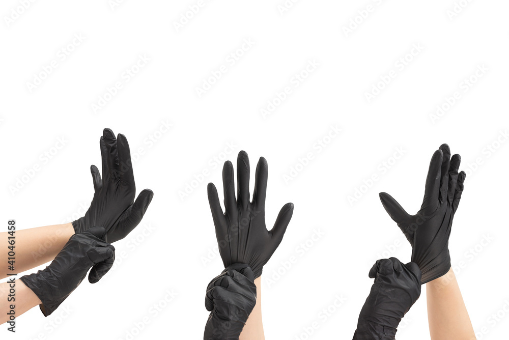 Woman puts on black rubber gloves.