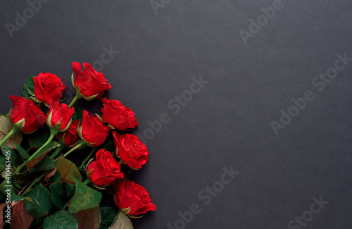 A bouquet of red roses with on a black background, copyspase.