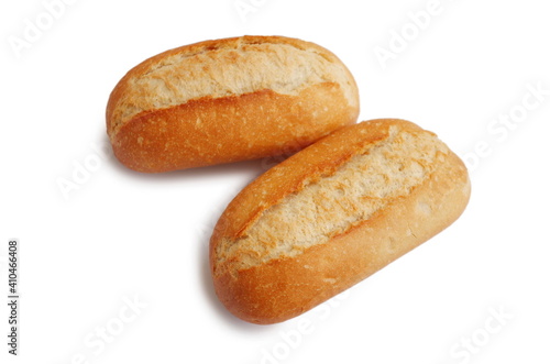 Two fresh crusty mini baguettes isolated on white bacground. Small baguette rolls. Food and breakfast background. Worldwide hunger concept.