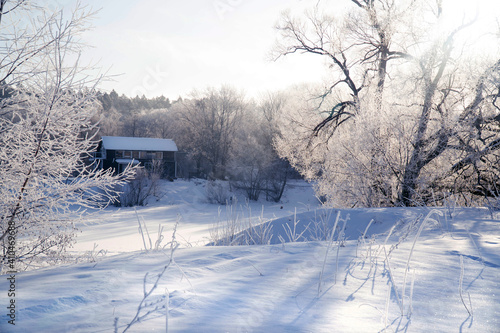 Rural winter landscape with a farm © Natalia