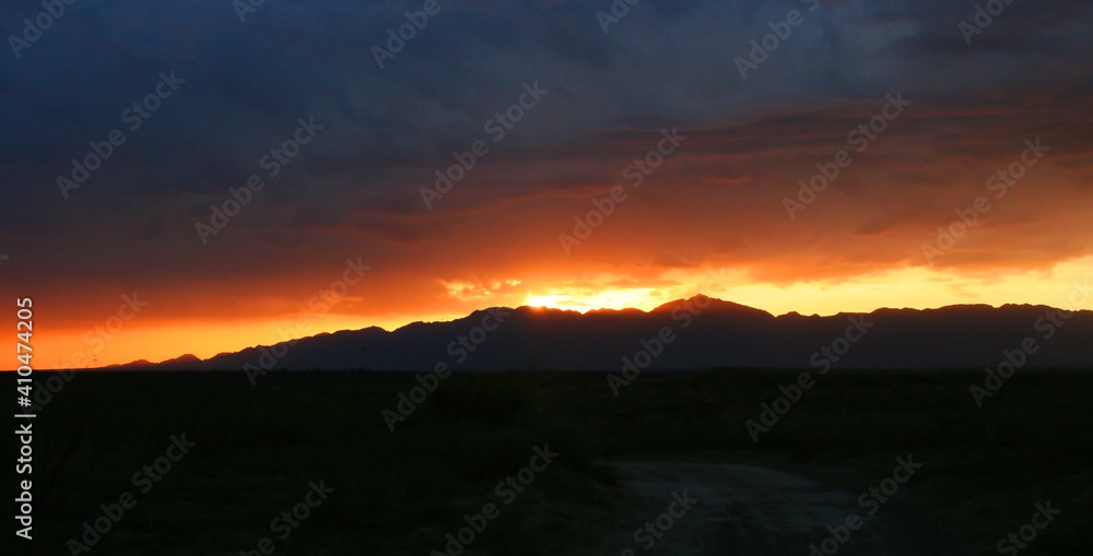 Beautiful summer sunset dramatic sky in Kazakhstan mountains. National park. Banner size with copy space.