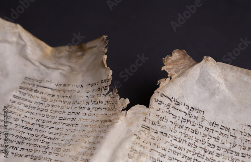 Old Bible scrolls lie on a black background. Religion. Bible. Bible books. Christianity. God. Hebrew. Old chronicles. Israel. Jerusalem.