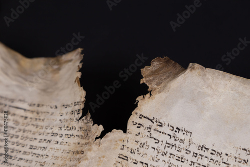 Old Bible scrolls lie on a black background. Religion. Bible. Bible books. Christianity. God. Hebrew. Old chronicles. Israel. Jerusalem.
