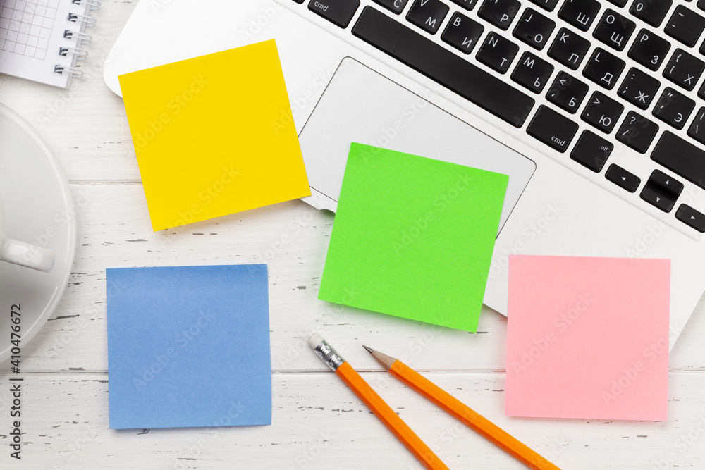 Office desk with colorful stickers, coffee and laptop Office desk with colorful stickers, coffee and laptop