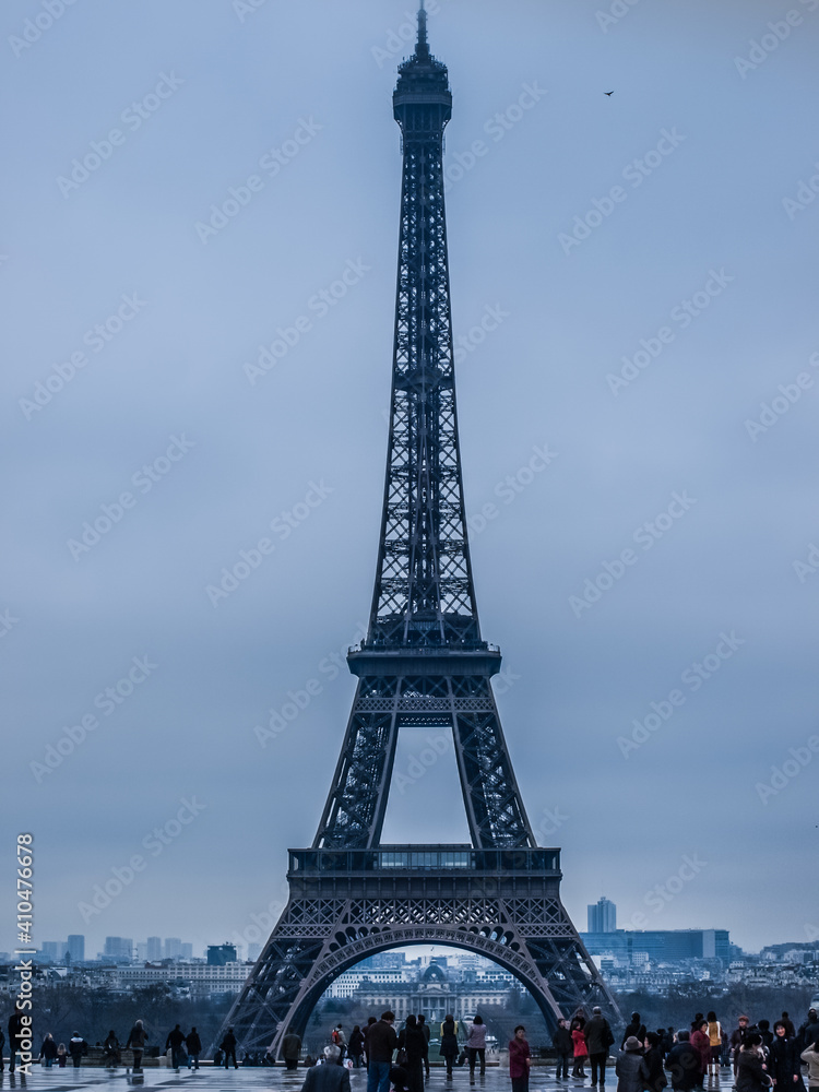 Paris.
Eiffel Tower In Paris. Looking Up At The Famous Iron Tower In Paris, Against A Gray Cloudy Sky. Travels