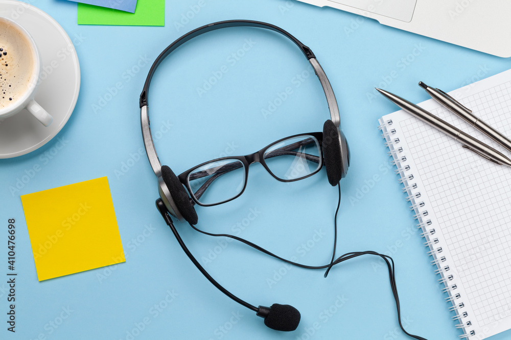 Office desk with headset and laptop. Work from home Office desk with headset and laptop. Work from home