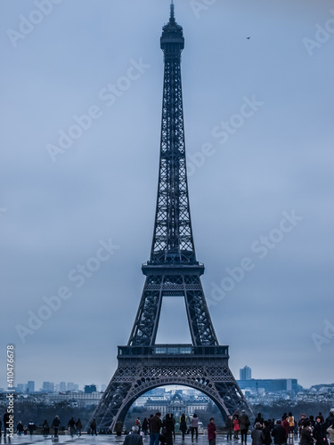Paris. Eiffel Tower In Paris. Looking Up At The Famous Iron Tower In Paris  Against A Gray Cloudy Sky. Travels