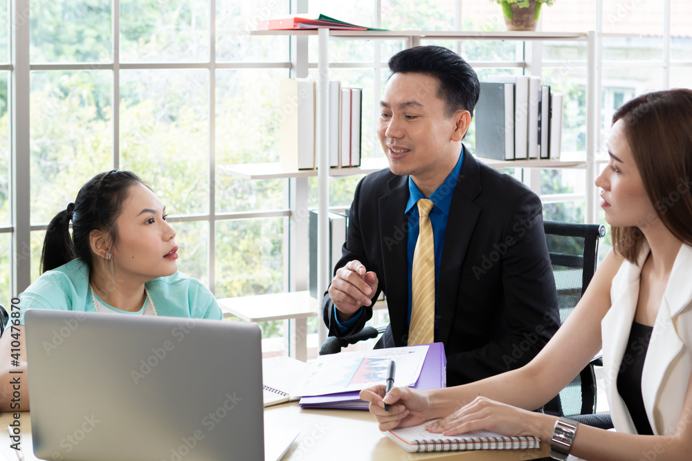 Disabled young female in wheelchair works in the modern office. Office workers are making a conversation. Disabled young female in wheelchair works in the modern office. Office workers are making a conversation.