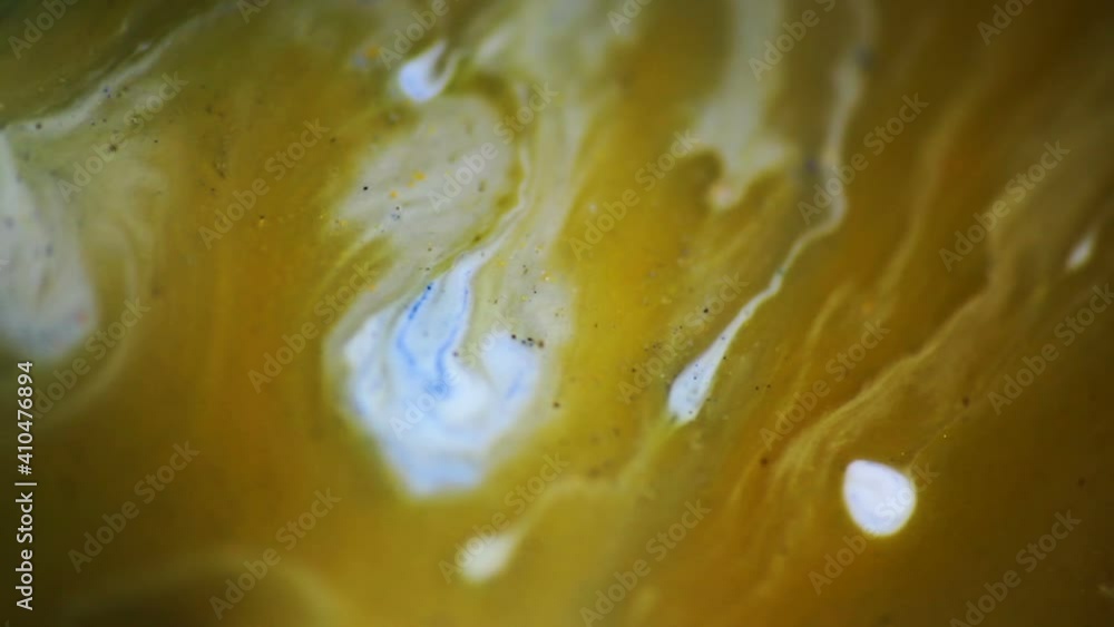 Luqiud vivid ochre color mixing together on white background. Painting, splash marble abstract texture Luqiud vivid ochre color mixing together on white background. Painting, splash marble abstract texture