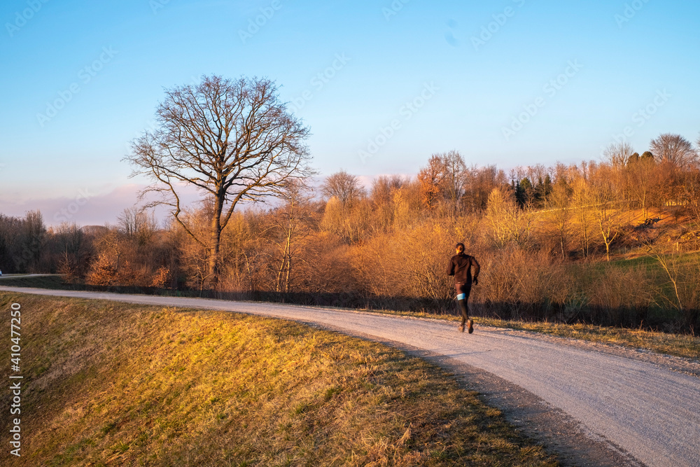 Italy, Province of Como, man running in the park, with a big and beautiful labero background. Italy, Province of Como, man running in the park, with a big and beautiful labero background.