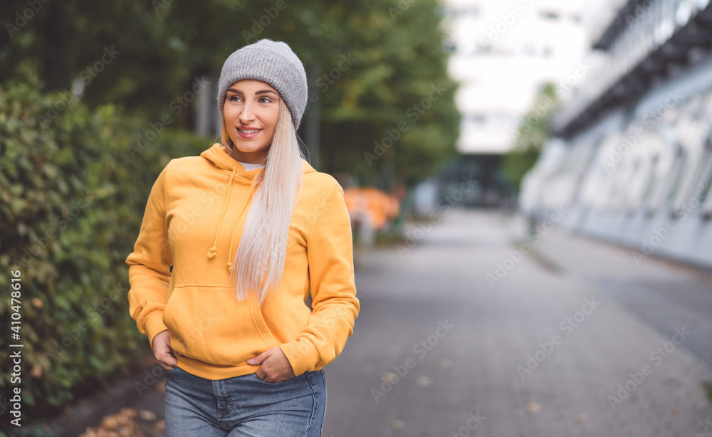 Smile portrait of a young woman looking to side. Outdoors daylight. Half length of cute girl wearing casual clothing. Smile portrait of a young woman looking to side. Outdoors daylight. Half length of cute girl wearing casual clothing.