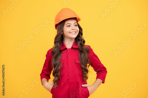 happy teenager girl in safety hard hat, builder © Olena