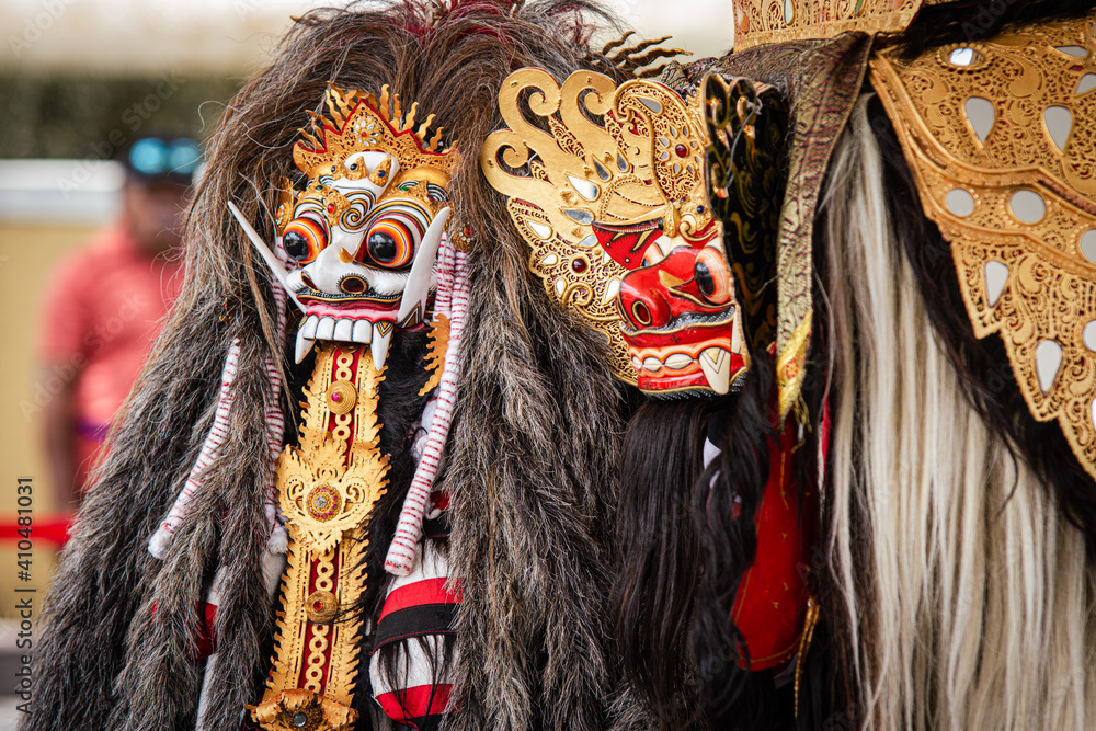 Traditional barong mask in Bali Indonesia used in religious ceremony. Dancing the traditional Legong dance in Pura Saraswati temple, Ubud, Bali, indonesia