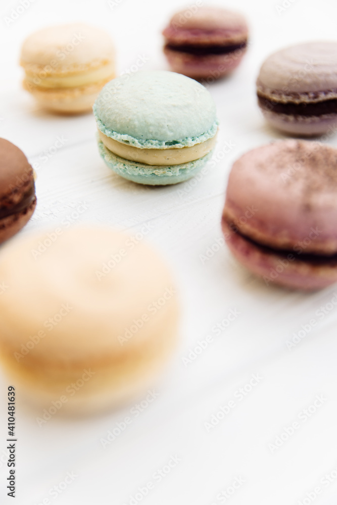 Macaroni or macaroni cake on white top background, colorful macaroons, pastel colors, vintage card, top view Macaroni or macaroni cake on white top background, colorful macaroons, pastel colors, vintage card, top view