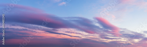 Scenic pink purple clouds against azure sky at sunset. Majestic vanilla sky panoramic shot. Beautiful pastel colored evening skyscape. Paradise heaven.