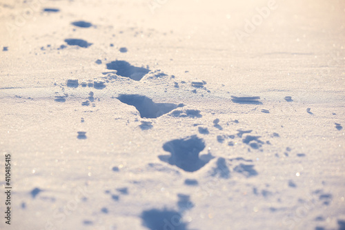 Human traces on a snow. Winter background. photo